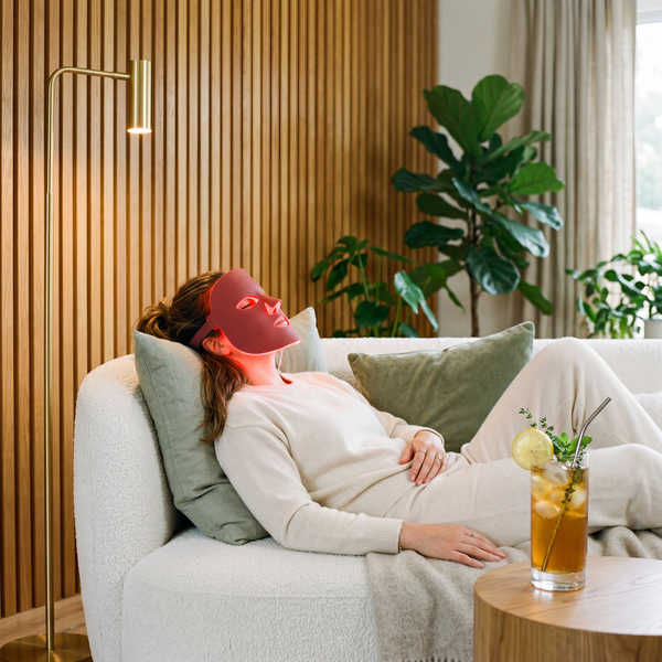 A guest trying a biohacking tool while enjoying a botanical mocktail